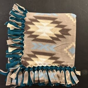 50x60” fleece tie blanket.  Southwest pattern fleece with teal fleece backing